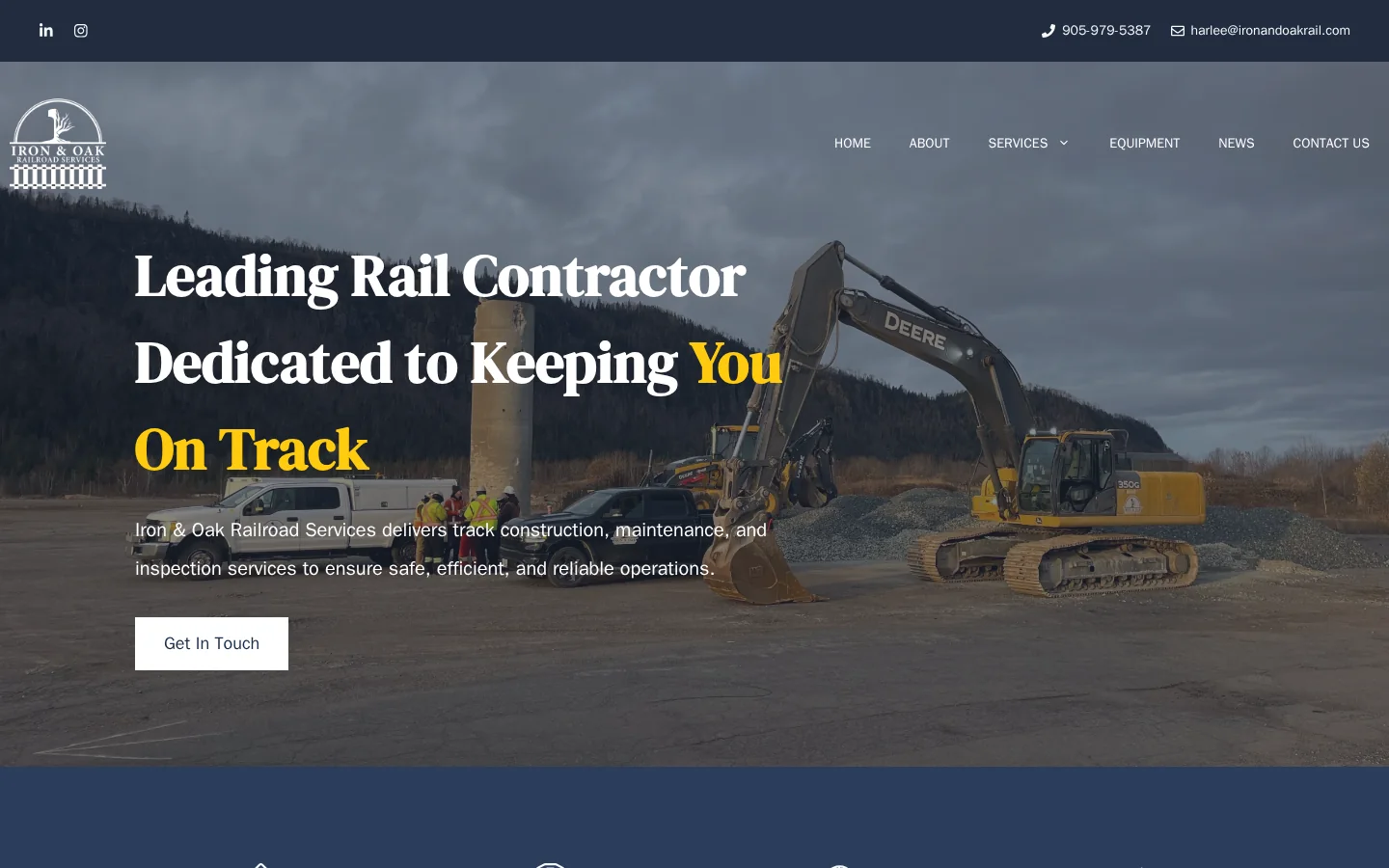 Iron & Oak Railroad Services homepage showing rail construction equipment