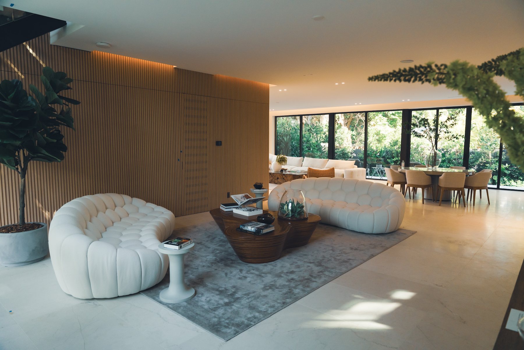 Warm contemporary living room framed by garden views