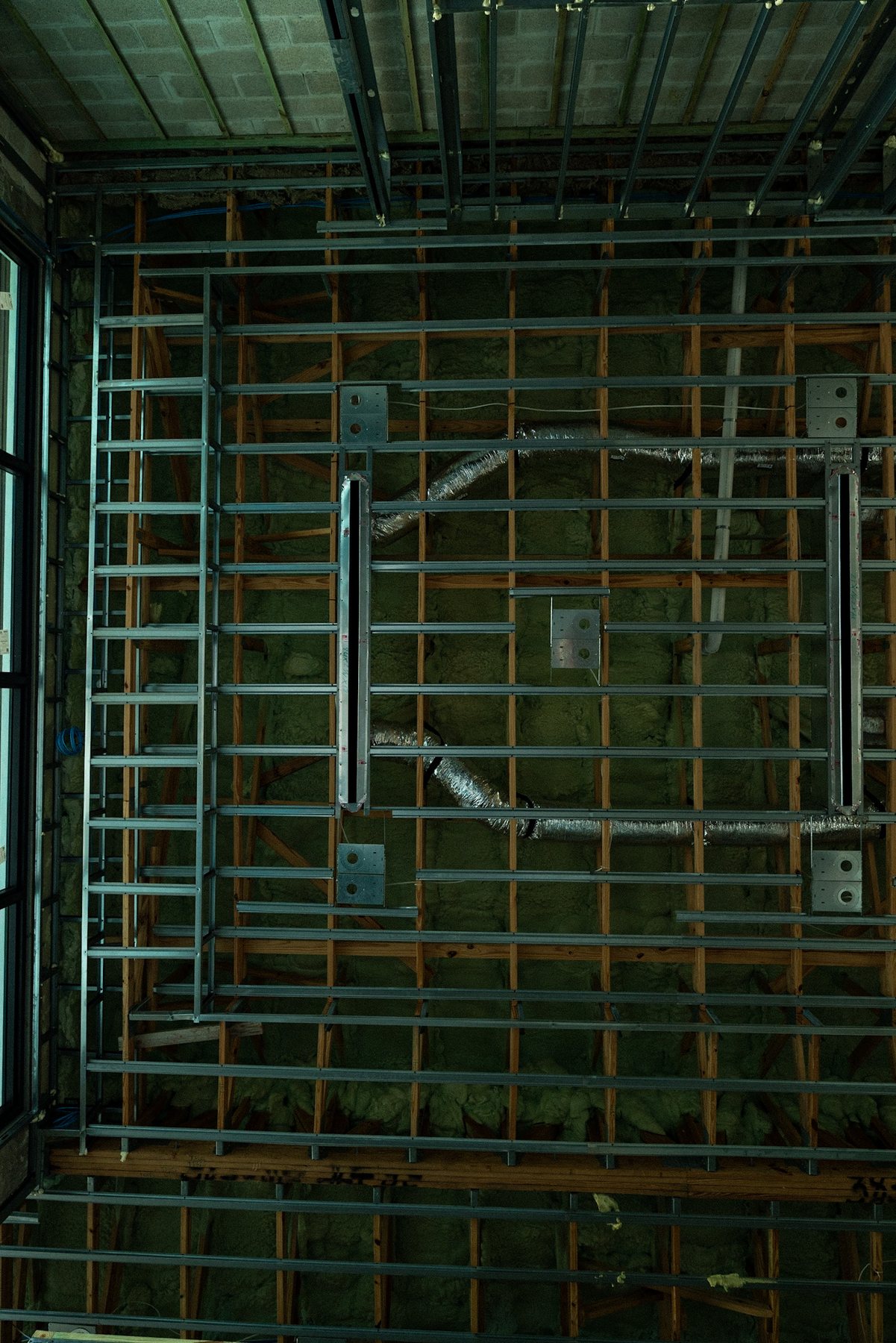 Dense ceiling framing revealing the building system