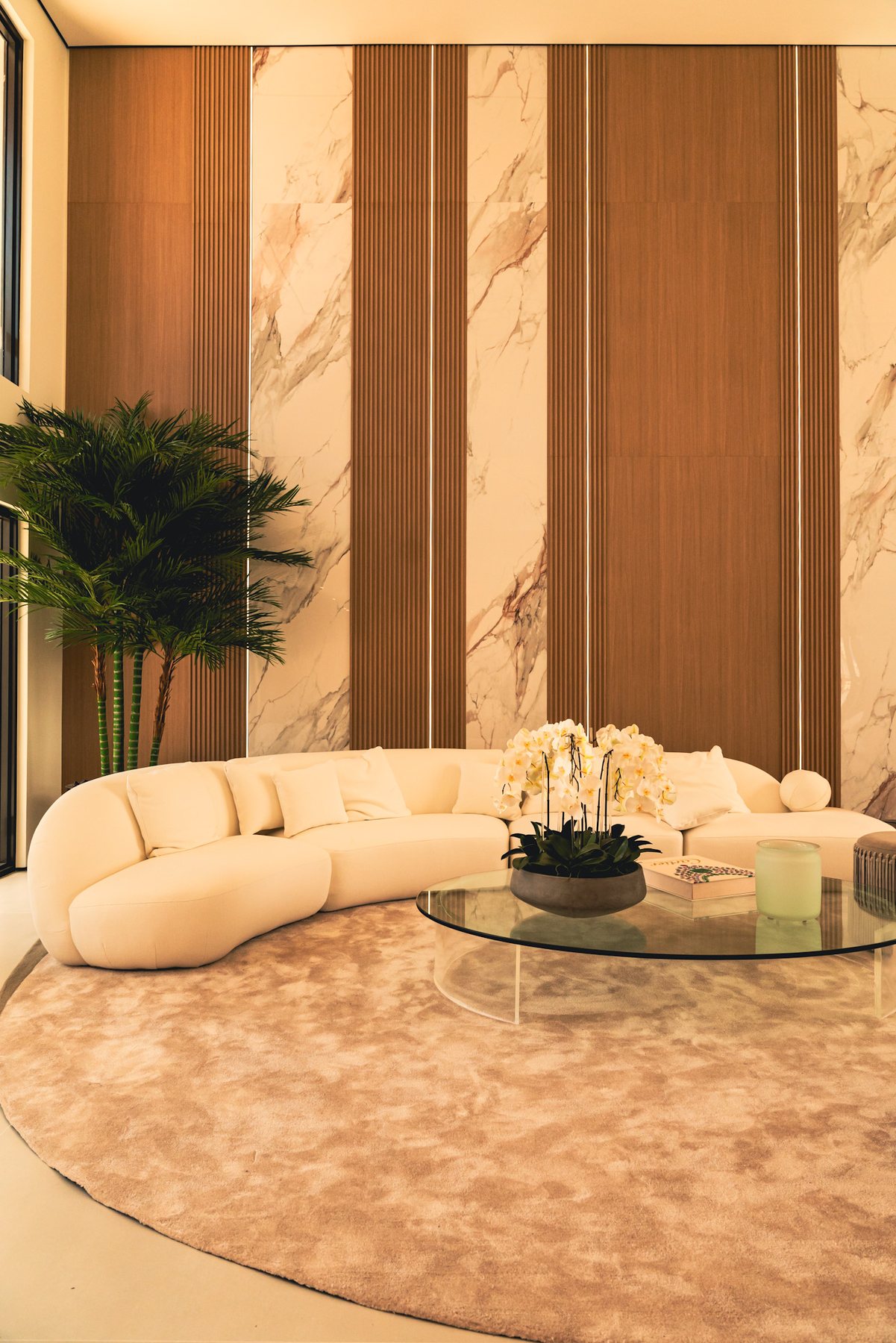 Refined living room with curved seating and warm stone