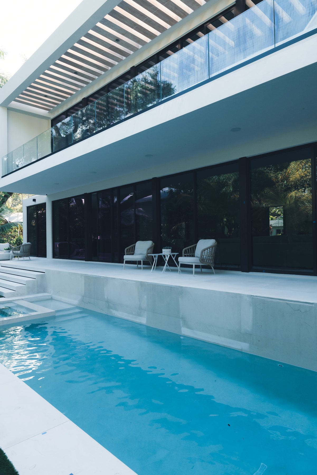 Private pool courtyard framed by deep overhangs