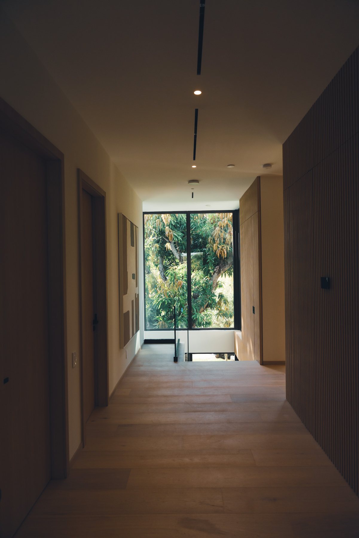 Quiet interior passage with natural light at the far end