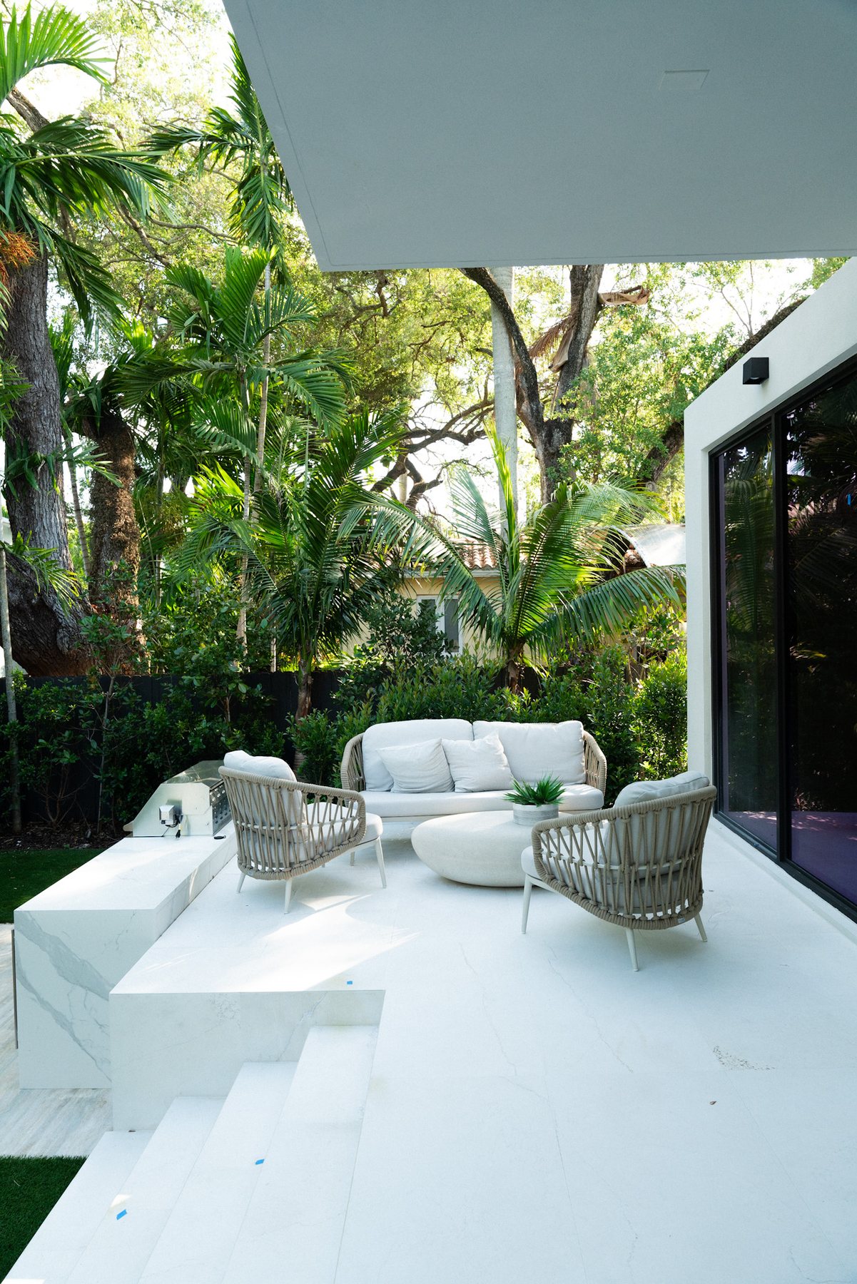 Covered outdoor room surrounded by lush garden planting