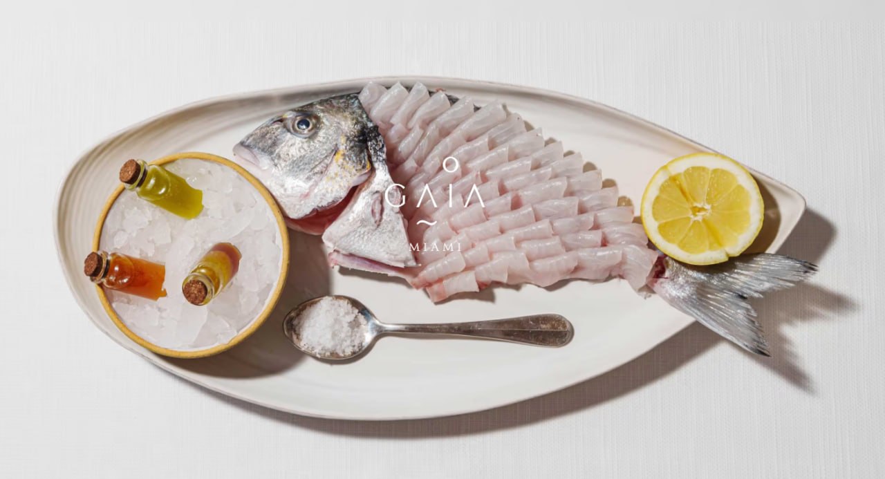 Gaia Miami seafood presentation with whole fish, lemon, sea salt, and olive oil